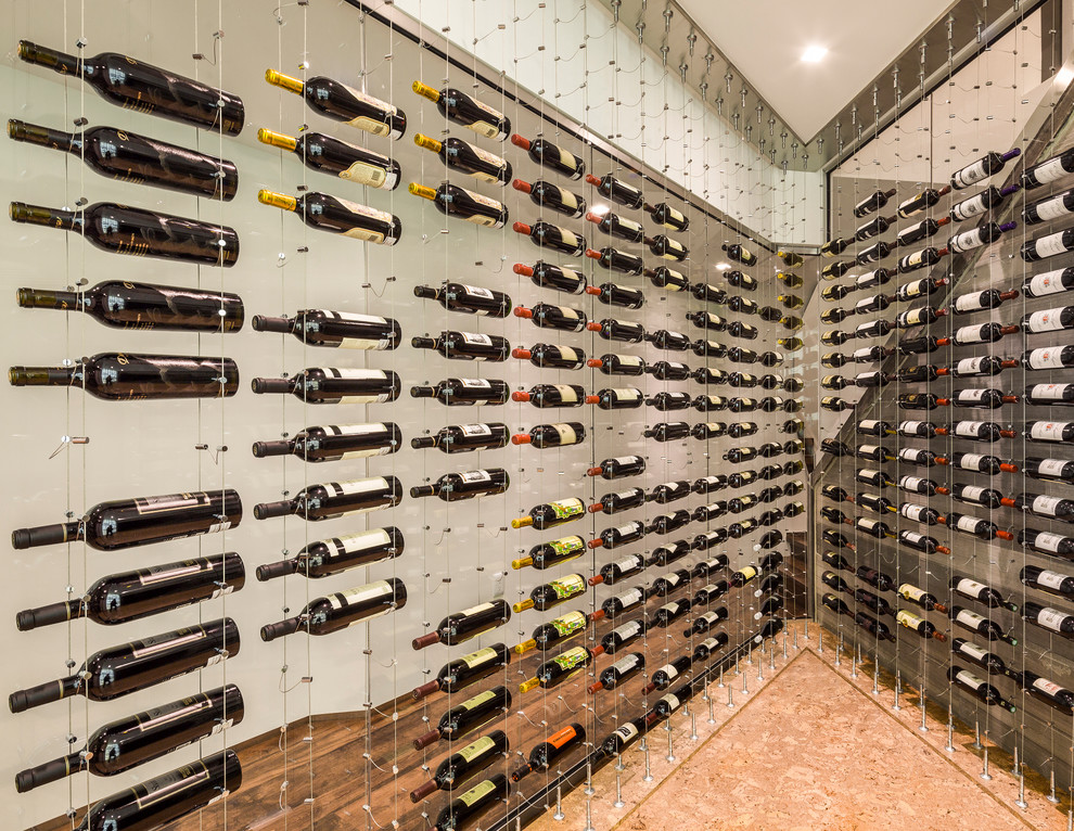 Photo of a contemporary wine cellar in Toronto with display racks and cork floors.