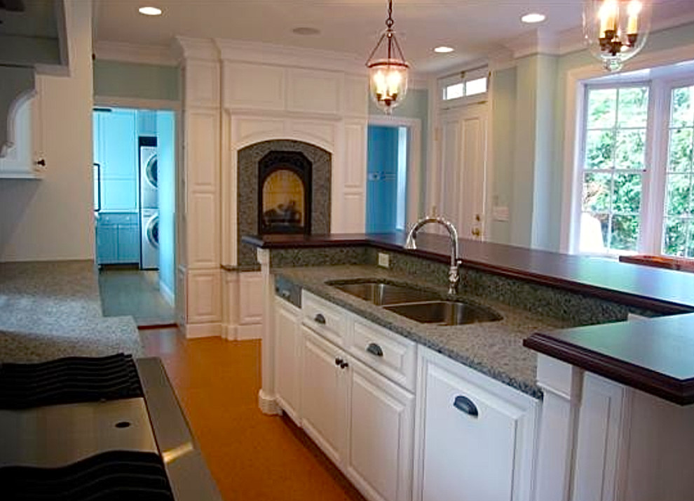 Design ideas for a large traditional galley eat-in kitchen in Providence with with island, raised-panel cabinets, white cabinets, granite benchtops, white splashback, stainless steel appliances, a double-bowl sink and medium hardwood floors.