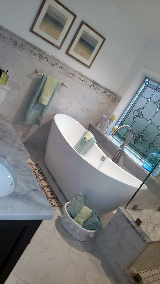 Example of a mid-sized transitional master black and white tile and porcelain tile porcelain tile freestanding bathtub design with white walls, an undermount sink, granite countertops, gray cabinets and a two-piece toilet