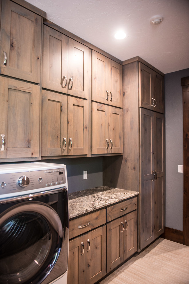 Example of a huge mountain style u-shaped gray floor utility room design with an undermount sink, flat-panel cabinets, light wood cabinets, granite countertops, blue walls, a side-by-side washer/dryer and multicolored countertops