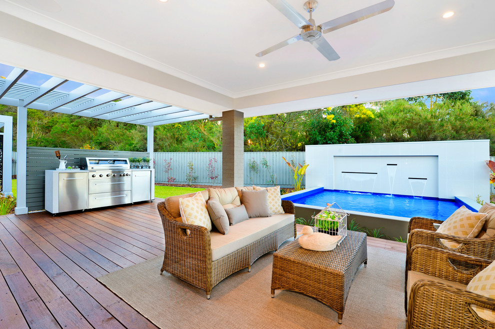 Photo of a country backyard verandah in Wollongong with a water feature and a roof extension.