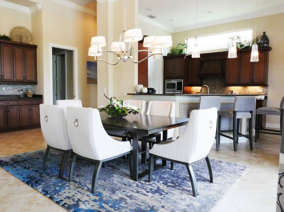 Example of a mid-sized transitional ceramic tile and brown floor kitchen/dining room combo design in Miami with beige walls and no fireplace