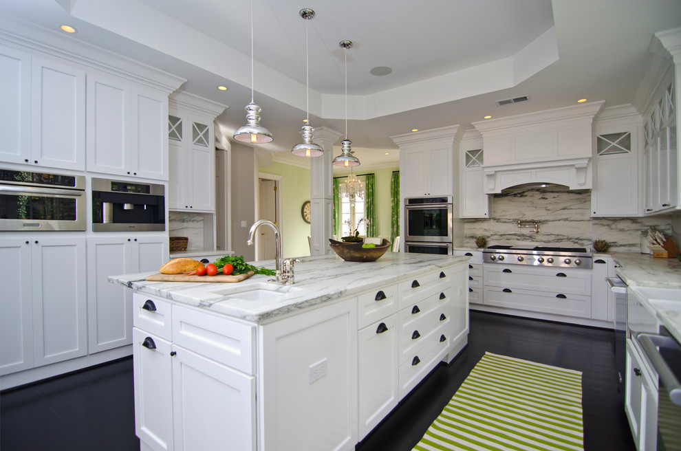 Inspiration for a transitional l-shaped dark wood floor eat-in kitchen remodel in DC Metro with a farmhouse sink, shaker cabinets, white cabinets, marble countertops, beige backsplash, stainless steel appliances, white walls and an island