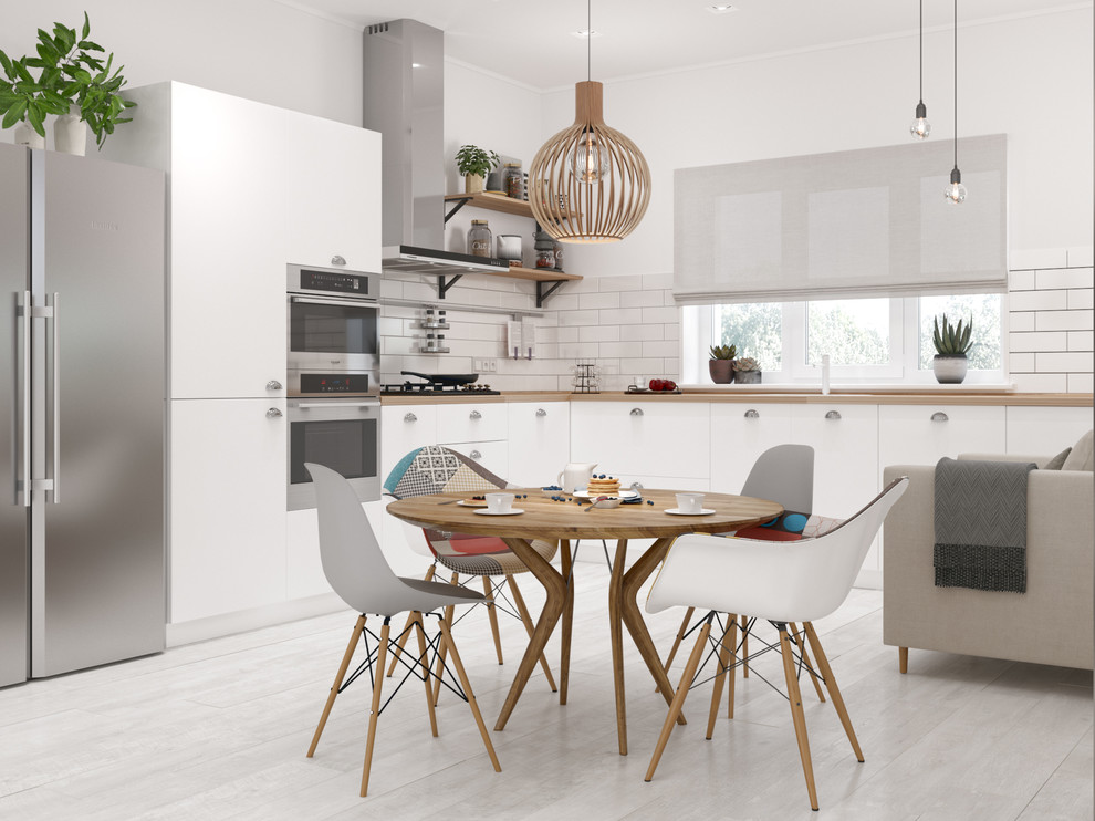 Inspiration for a mid-sized scandinavian l-shaped separate kitchen in Other with flat-panel cabinets, white cabinets, wood benchtops, white splashback, ceramic splashback, stainless steel appliances, laminate floors, no island and white floor.