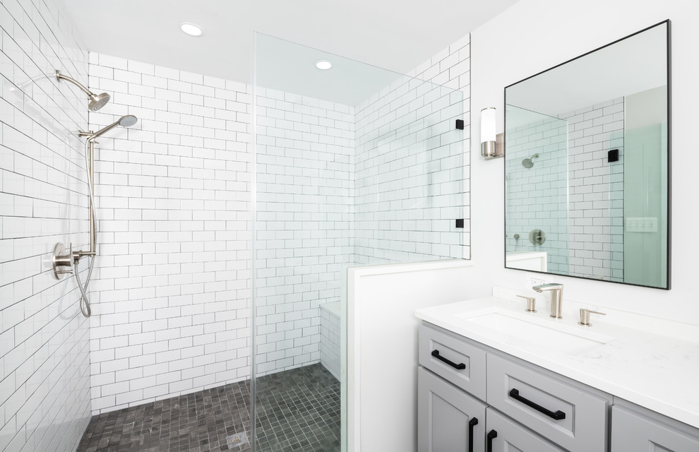 Inspiration for a mid-sized transitional 3/4 bathroom in DC Metro with recessed-panel cabinets, grey cabinets, an alcove shower, a two-piece toilet, white tile, subway tile, white walls, an undermount sink, engineered quartz benchtops, brown floor, a hinged shower door and white benchtops.