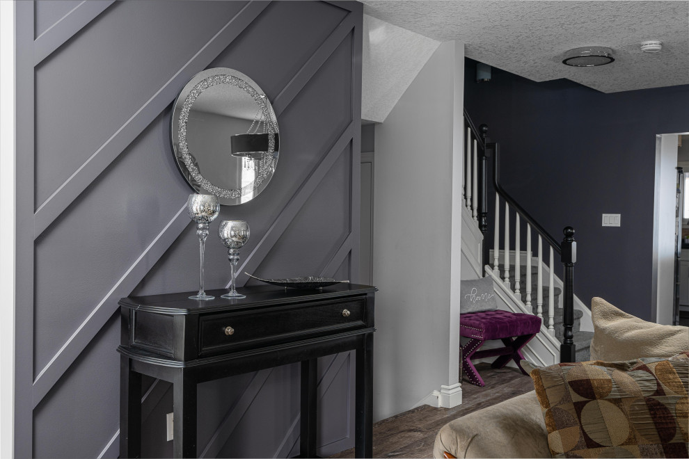Inspiration for a mid-sized transitional dark wood floor, brown floor and wall paneling single front door remodel in Toronto with multicolored walls and a white front door
