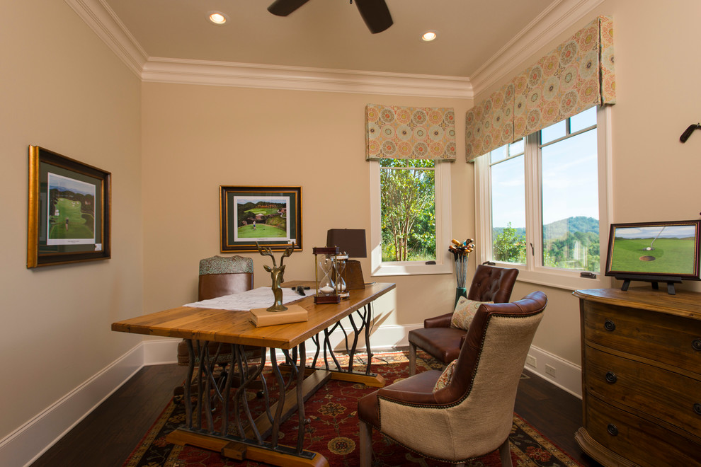This is an example of a country home office in Other with beige walls.