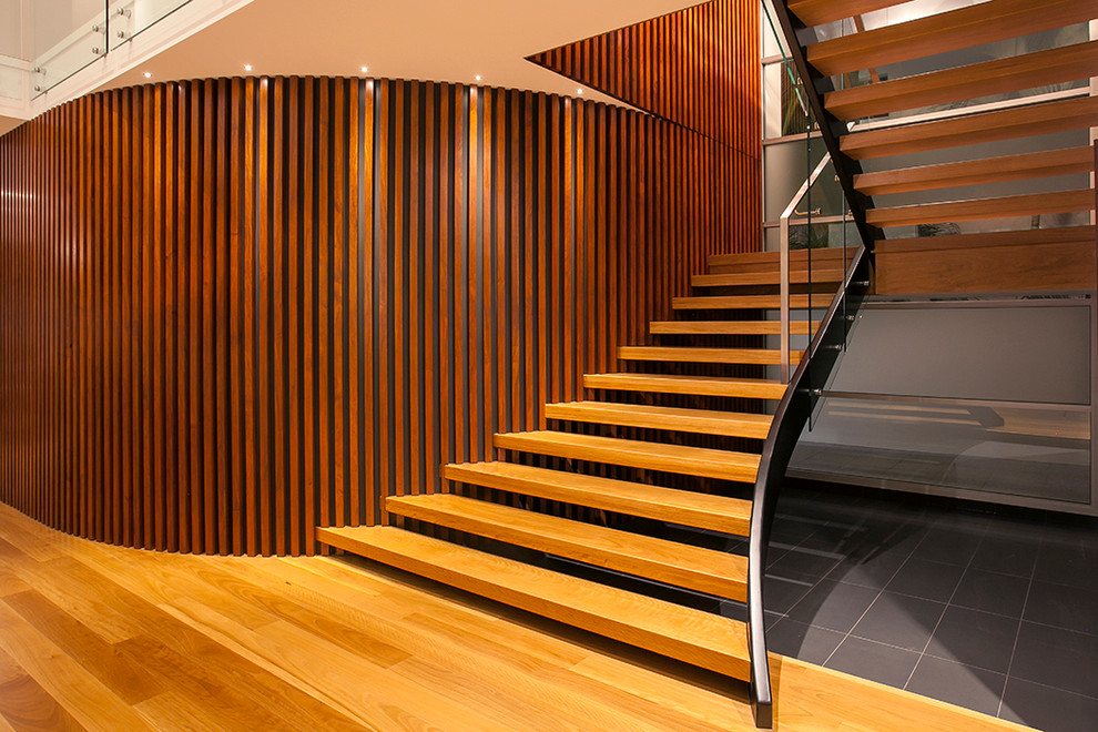 Photo of a contemporary wood u-shaped staircase in Sunshine Coast with wood risers.