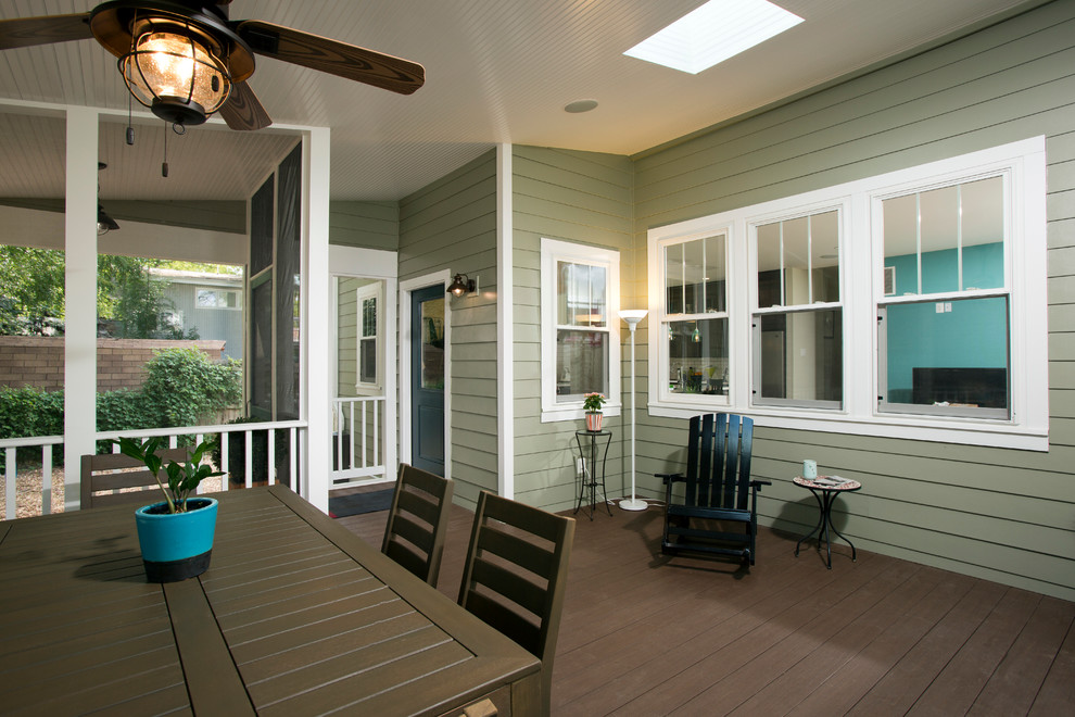 This is an example of a mid-sized transitional backyard screened-in verandah in DC Metro with decking and a roof extension.