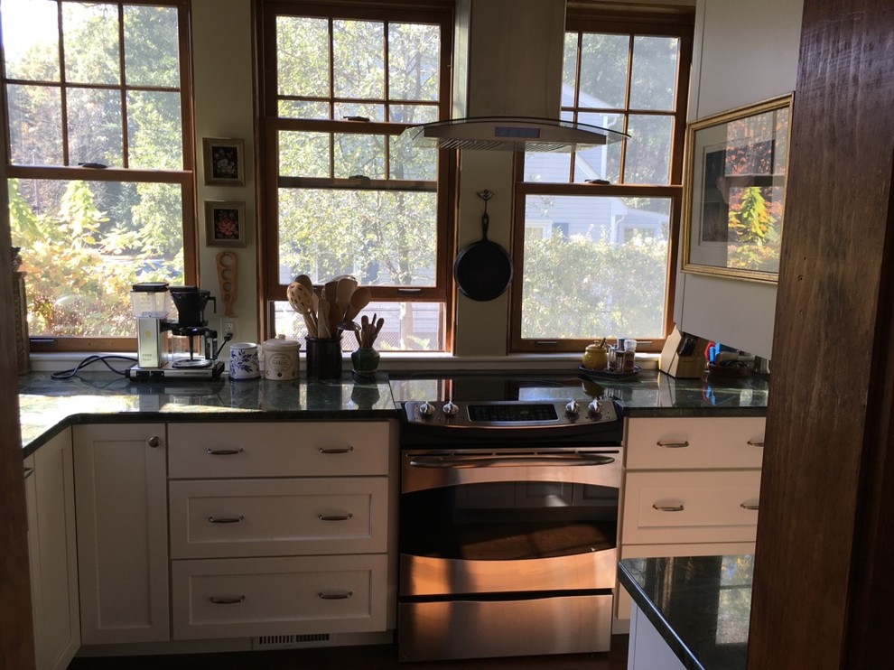Inspiration for a transitional u-shaped dark wood floor kitchen remodel in Boston with an undermount sink, shaker cabinets, white cabinets, granite countertops and stainless steel appliances