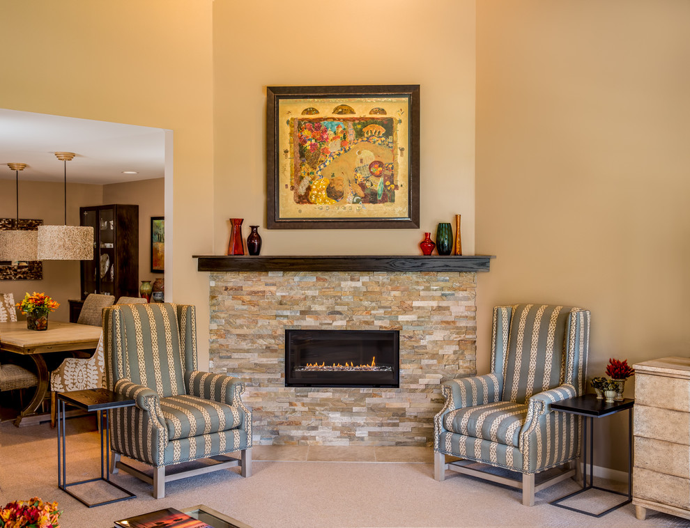 Mid-sized transitional family room in Detroit with carpet, a corner fireplace, a stone fireplace surround, a freestanding tv and brown walls.