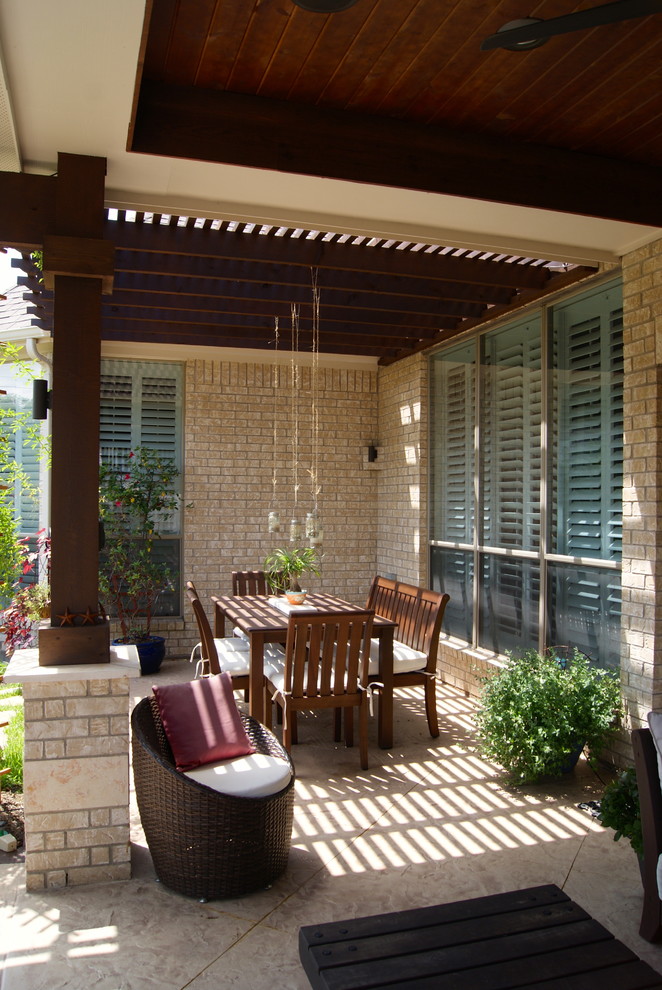 This is an example of a transitional backyard patio in Houston with a pergola.