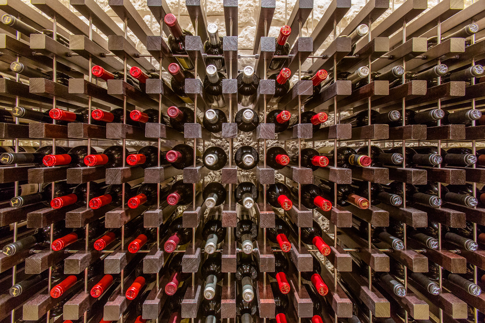 Inspiration for a mid-sized contemporary wine cellar in Boston with storage racks, travertine floors and grey floor.