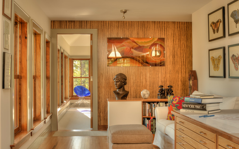 Mid-sized contemporary hallway in Other with beige walls and light hardwood floors.