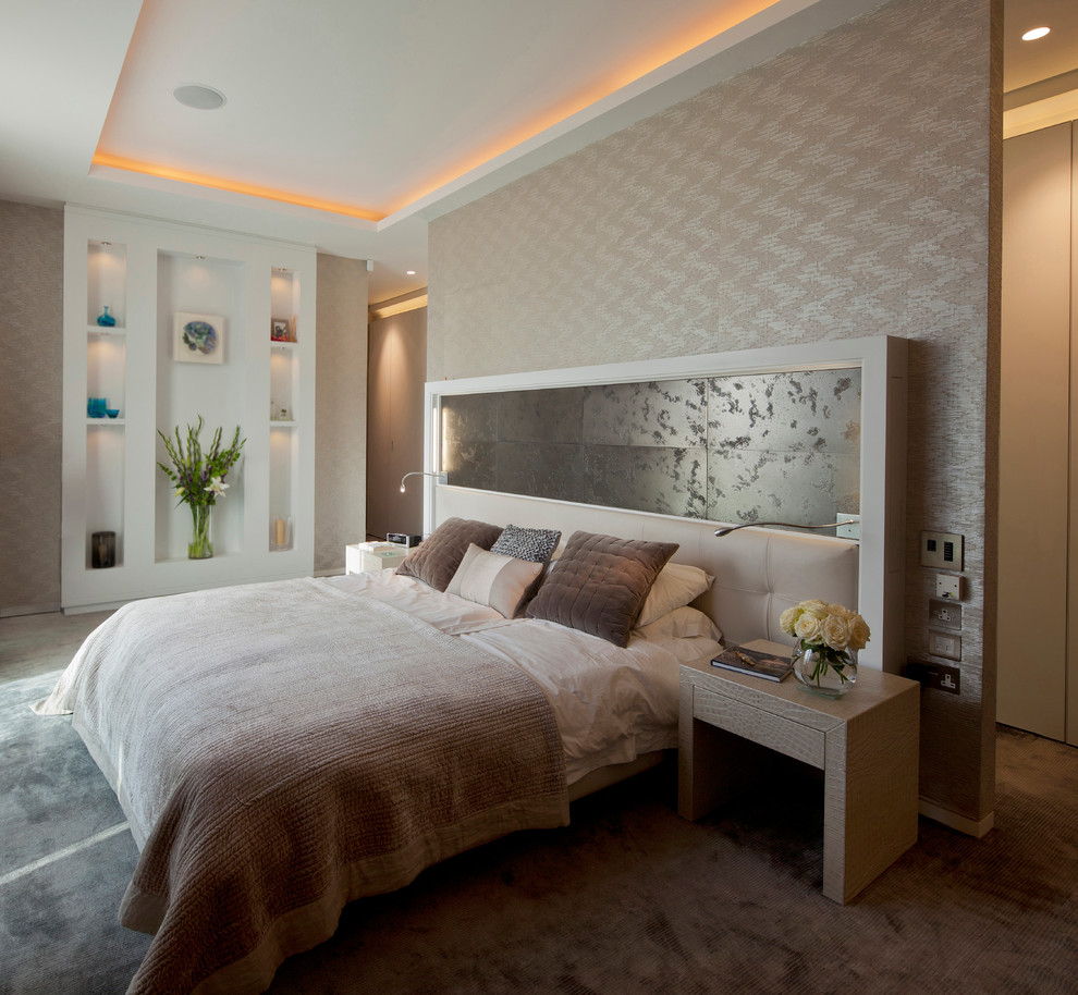 Contemporary bedroom in London with beige walls, carpet and grey floor.