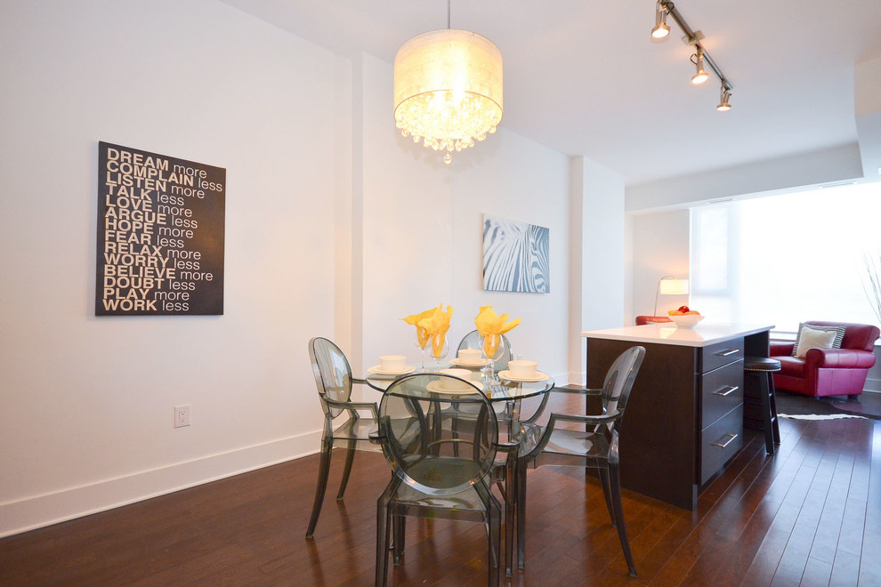 Small modern kitchen/dining combo in Ottawa with medium hardwood floors and white walls.