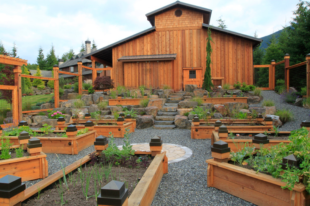 Photo of a mid-sized traditional backyard full sun formal garden in Seattle with gravel and a container garden.