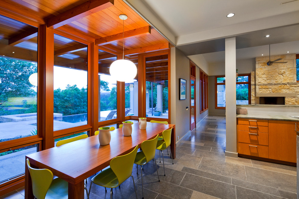 Contemporary dining room in Austin with slate floors.