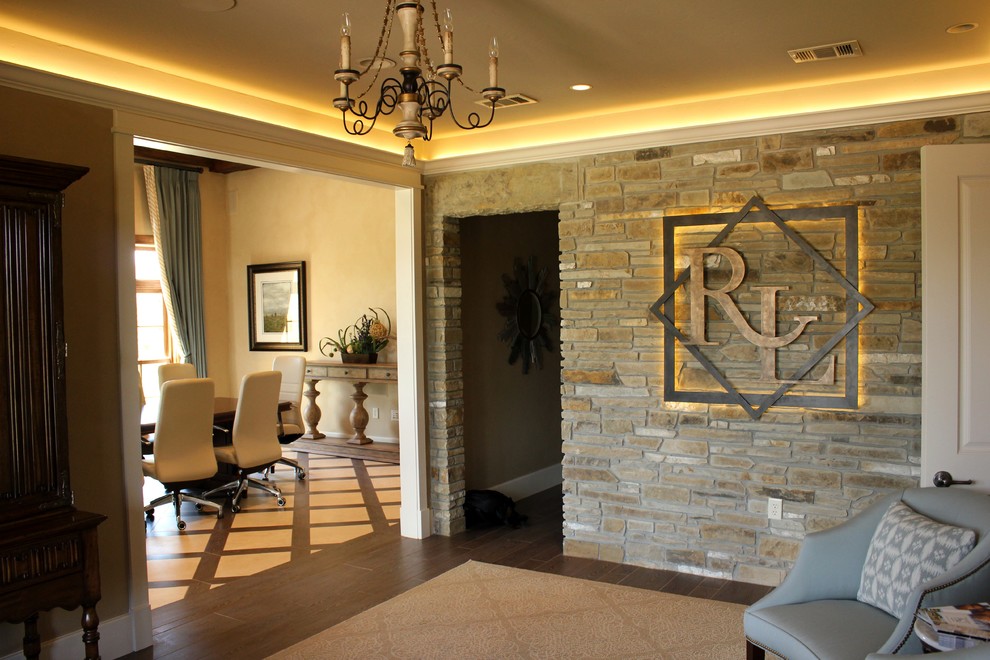 Large transitional dark wood floor foyer photo with beige walls and a dark wood front door