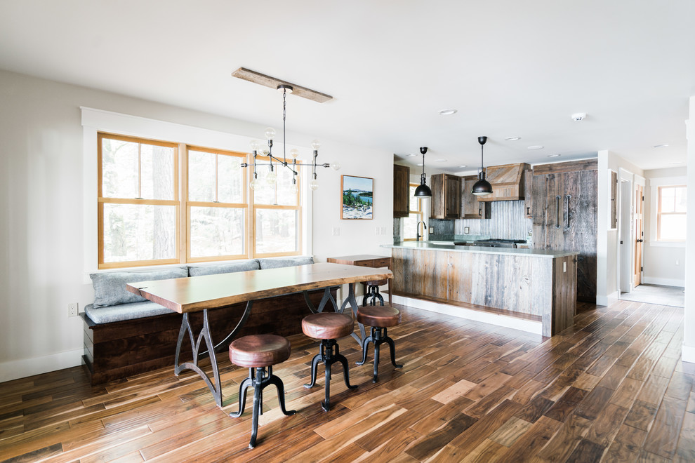 Photo of a country kitchen/dining combo in Portland Maine with white walls, dark hardwood floors and brown floor.