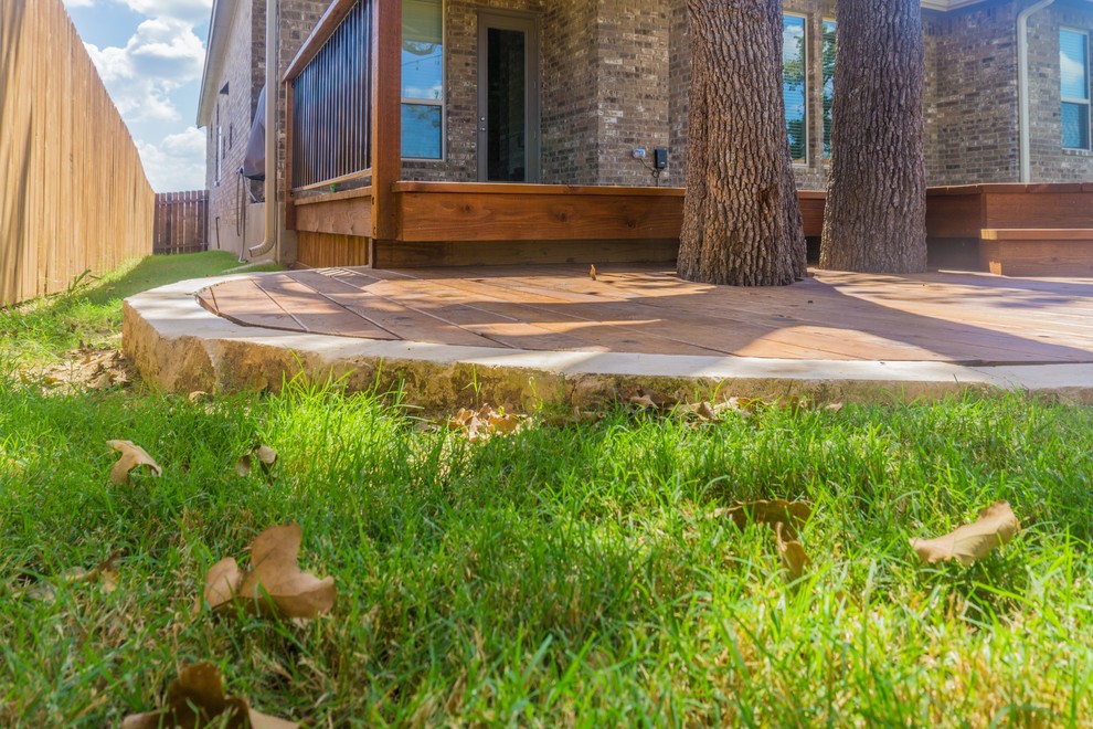 Mid-sized transitional backyard home design photo in Austin with a roof extension