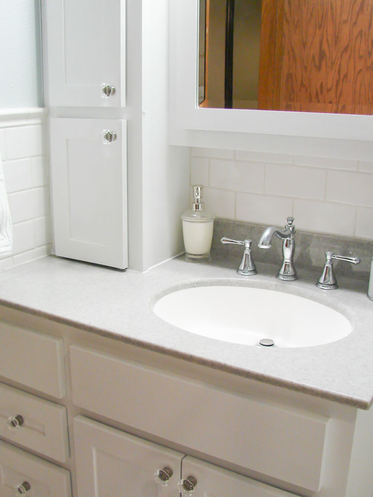 Corner shower - mid-sized transitional 3/4 white tile and subway tile corner shower idea with shaker cabinets, white cabinets, a two-piece toilet, blue walls, an undermount sink and quartz countertops