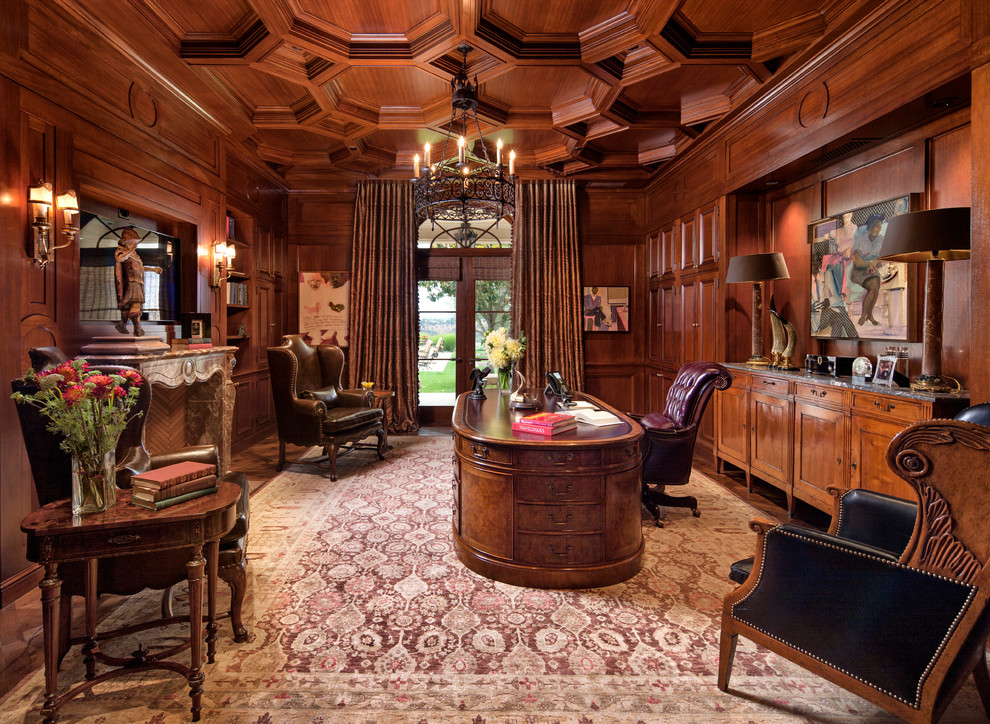 Example of a classic freestanding desk dark wood floor study room design in Los Angeles with brown walls and a standard fireplace