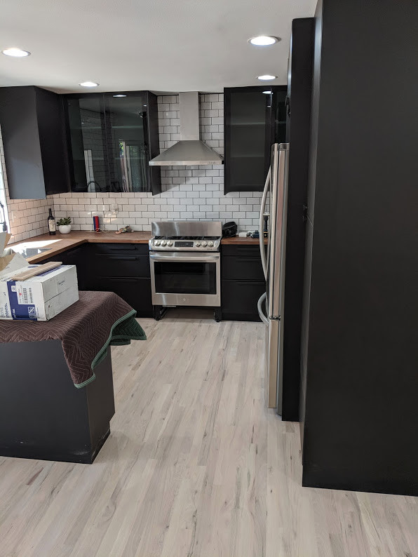 Trendy light wood floor kitchen photo in Milwaukee