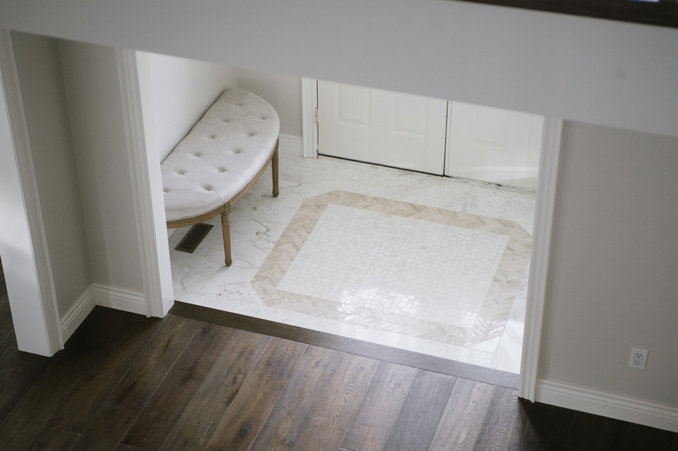 Transitional marble floor and white floor foyer photo in Toronto