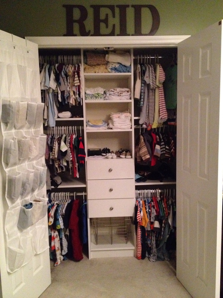 Inspiration for a small gender-neutral carpeted reach-in closet remodel with raised-panel cabinets and white cabinets