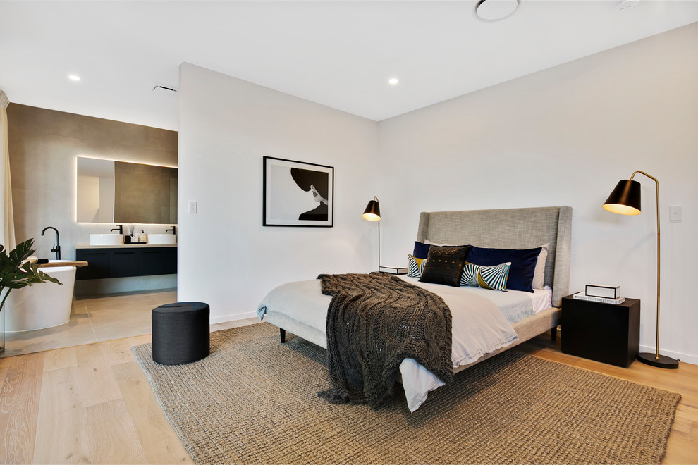 Contemporary master bedroom in Sunshine Coast with white walls, light hardwood floors and beige floor.