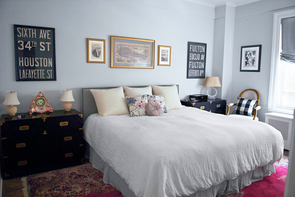 This is an example of a small transitional master bedroom in New York with grey walls and medium hardwood floors.