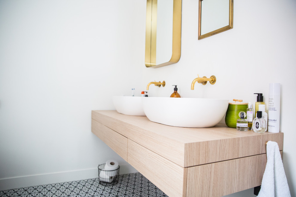 Inspiration for a modern master bathroom in London with white walls, ceramic floors, a vessel sink, laminate benchtops, multi-coloured floor and brown benchtops.