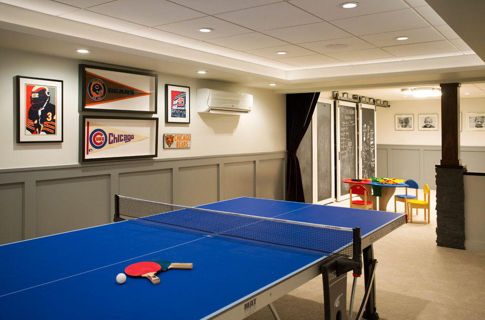 Large transitional fully buried basement in Boston with beige walls, carpet, a standard fireplace and a game room.