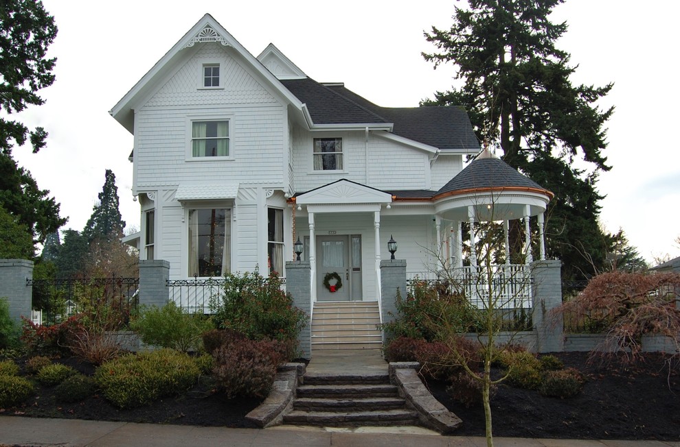 Inspiration for a mid-sized traditional two-storey white exterior in Portland with wood siding and a gable roof.