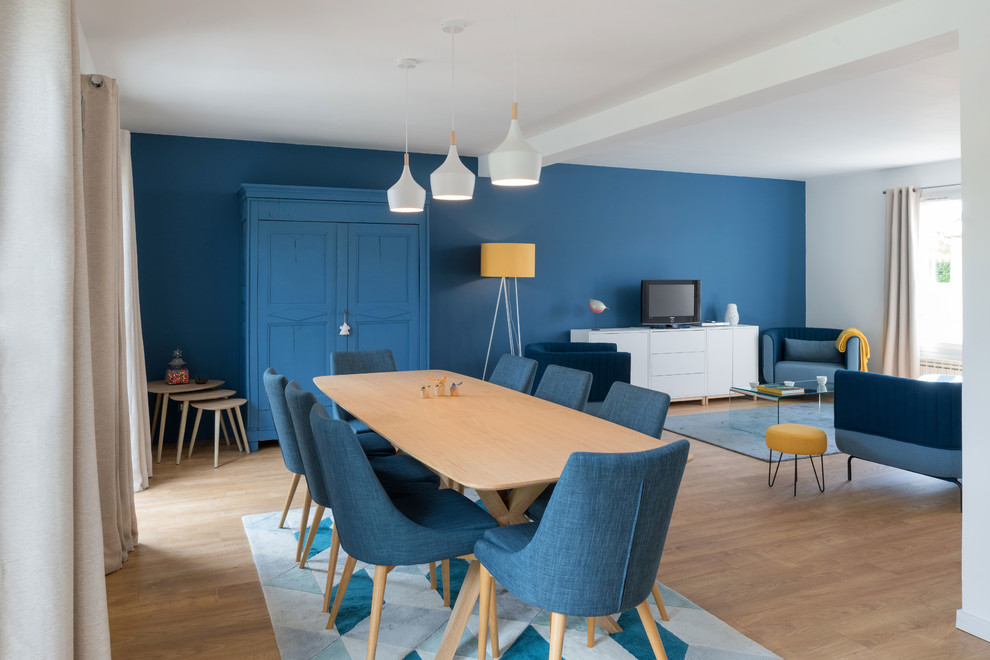 Design ideas for a large scandinavian open plan dining in Lyon with blue walls, light hardwood floors and no fireplace.