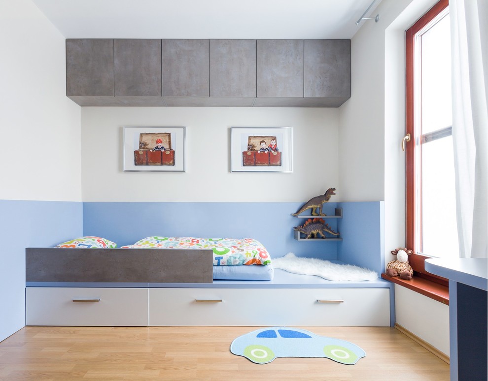 Design ideas for a contemporary kids' room for boys in Other with light hardwood floors and multi-coloured walls.