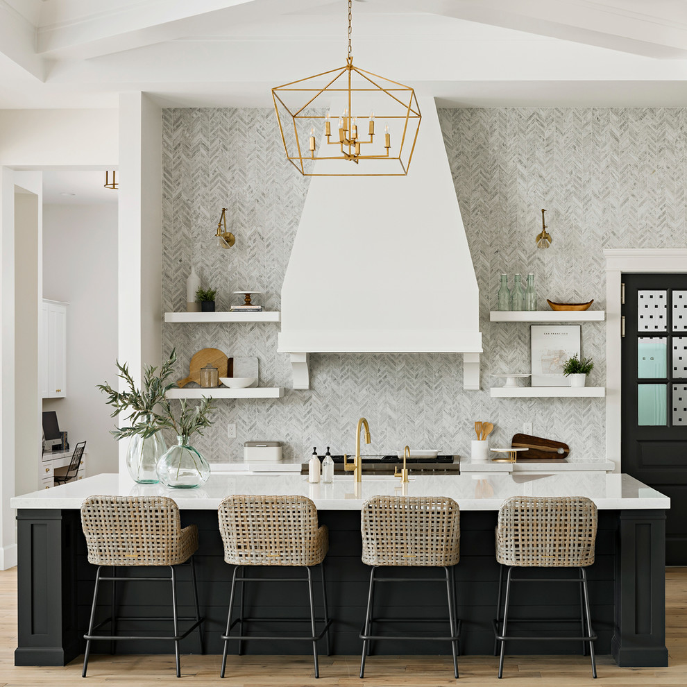 Design ideas for a transitional galley kitchen in Phoenix with quartz benchtops, open cabinets, black cabinets, grey splashback, light hardwood floors, with island, brown floor and white benchtop.