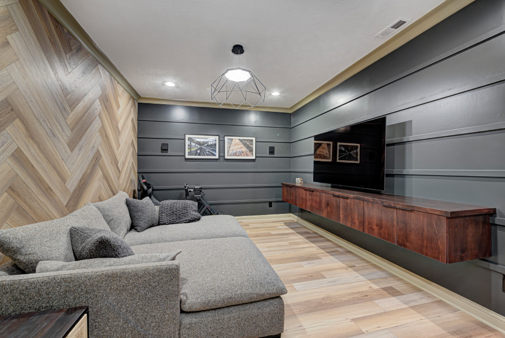 Inspiration for a medium sized contemporary enclosed games room in Indianapolis with multi-coloured walls, light hardwood flooring, brown floors, panelled walls and a wall mounted tv.