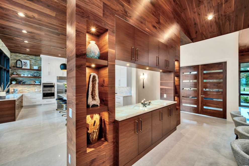 Large transitional beige floor, wood ceiling and wood wall dining room photo in Orlando