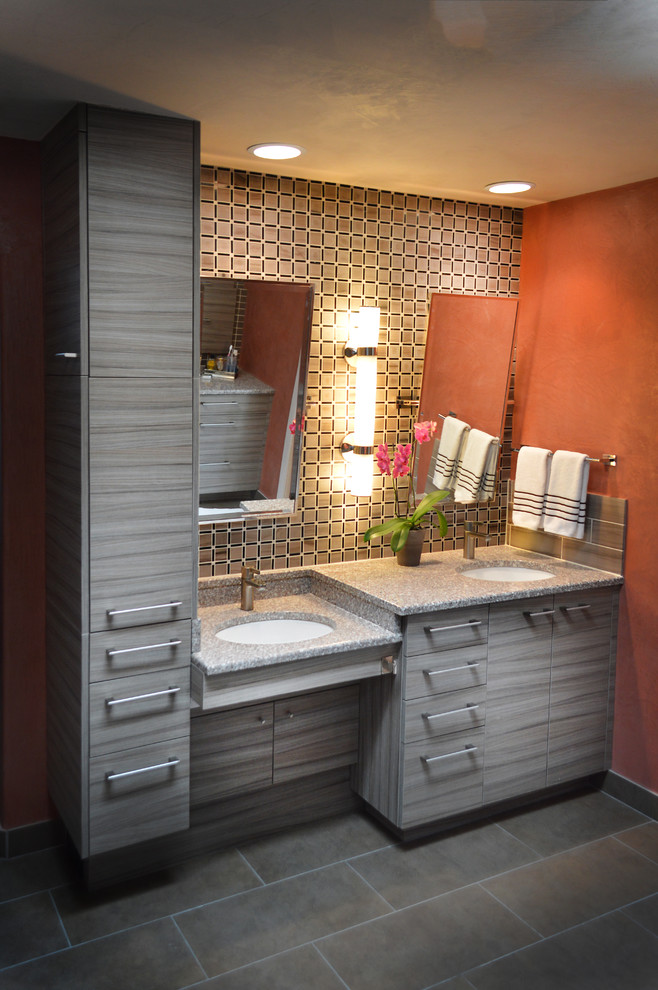 This is an example of a large modern master bathroom in Albuquerque with a drop-in sink, flat-panel cabinets, medium wood cabinets, granite benchtops, an alcove shower, a two-piece toilet, brown tile, glass tile, orange walls and slate floors.