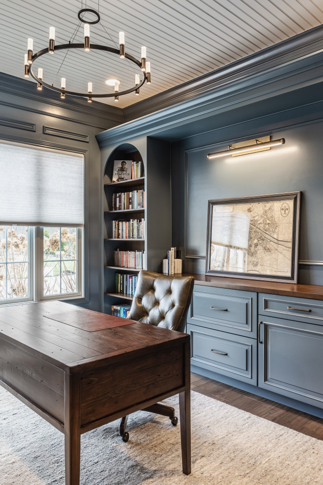 Home office - transitional freestanding desk dark wood floor, brown floor and shiplap ceiling home office idea in Indianapolis with blue walls