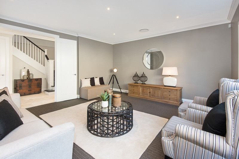 This is an example of a large contemporary enclosed home theatre in Sydney with grey walls and carpet.