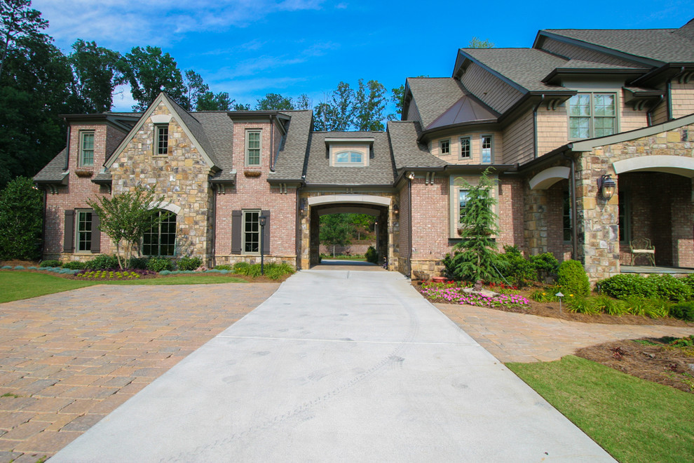 Design ideas for a large traditional three-storey beige exterior in Atlanta with stone veneer.