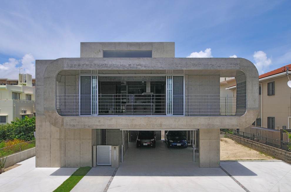 This is an example of an industrial two-storey concrete grey house exterior in Other with a flat roof.