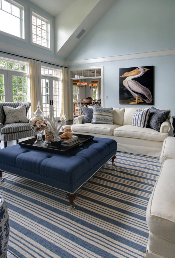 Large beach style enclosed living room in Portland with blue walls and dark hardwood floors.
