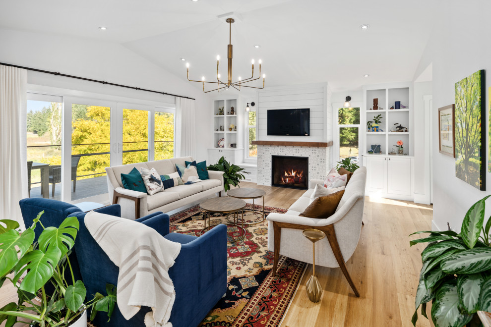 Farmhouse open plan living room in Vancouver with white walls, laminate floors, a tiled fireplace surround, a wall mounted tv and beige floors.