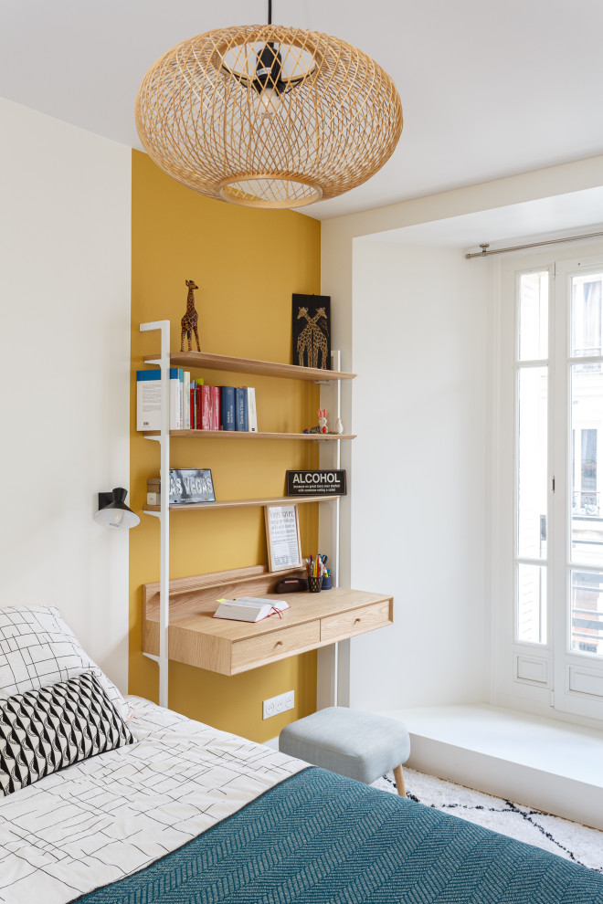 This is an example of a medium sized contemporary bedroom in Paris with yellow walls, light hardwood flooring and brown floors.