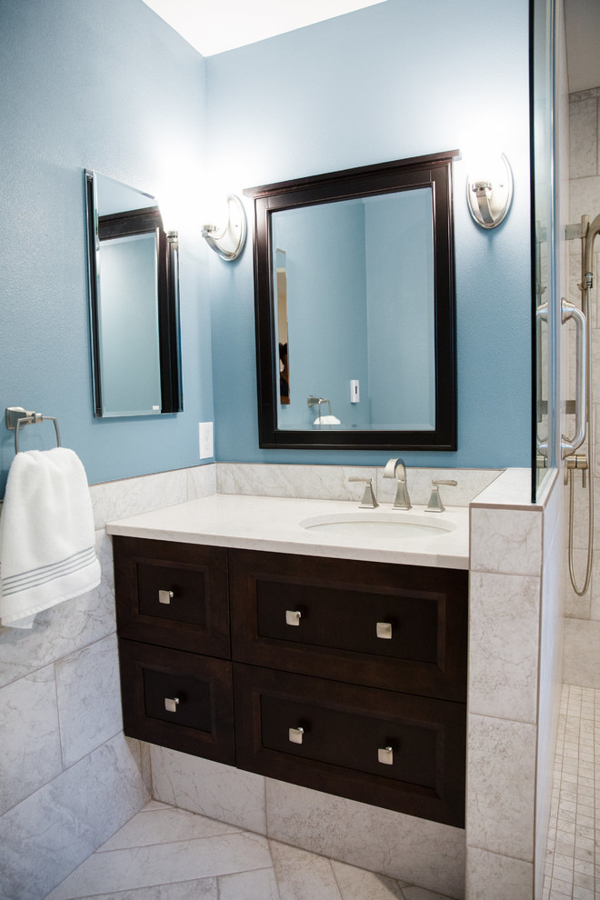 Mid-sized transitional master bathroom in Seattle with flat-panel cabinets, dark wood cabinets, an open shower, gray tile, porcelain tile, blue walls, porcelain floors, an undermount sink and engineered quartz benchtops.