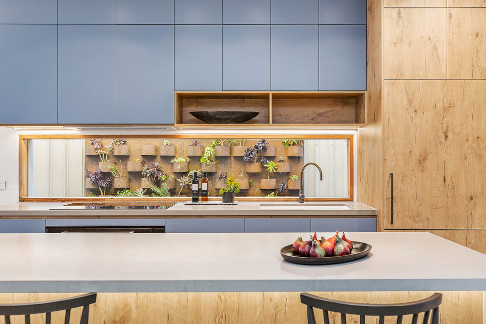 Mid-sized contemporary open plan kitchen in Melbourne with an undermount sink, medium wood cabinets, concrete benchtops, window splashback, concrete floors, with island, grey floor and grey benchtop.